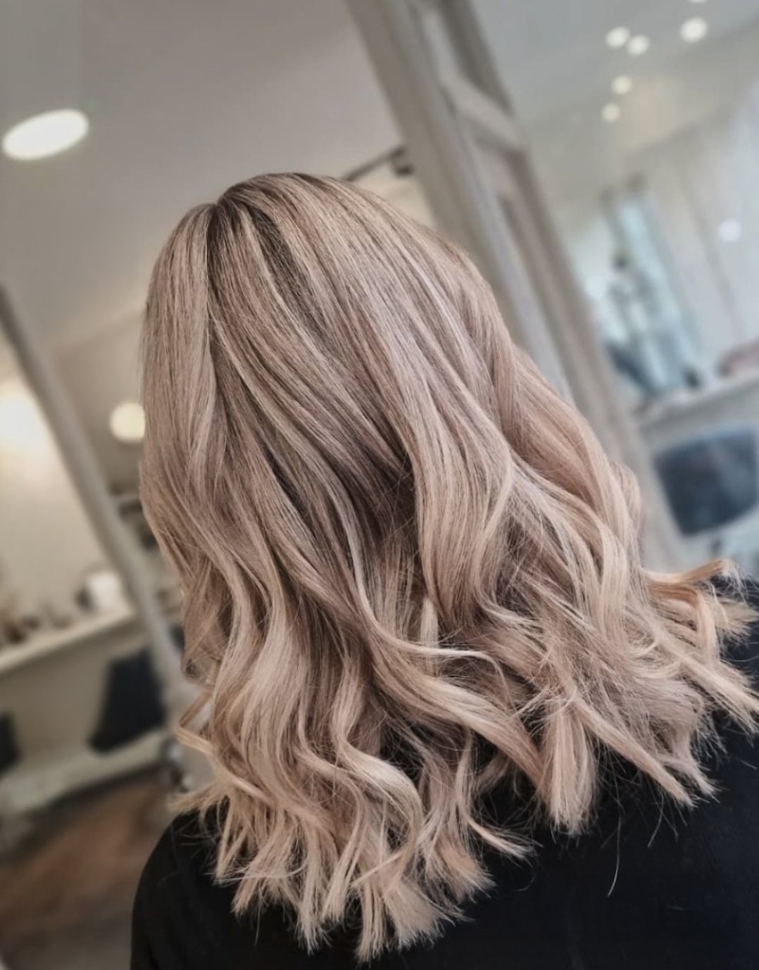 Back view of blonde wavy hairstyle styled at Albert Fields salon in Goring-on-Thames