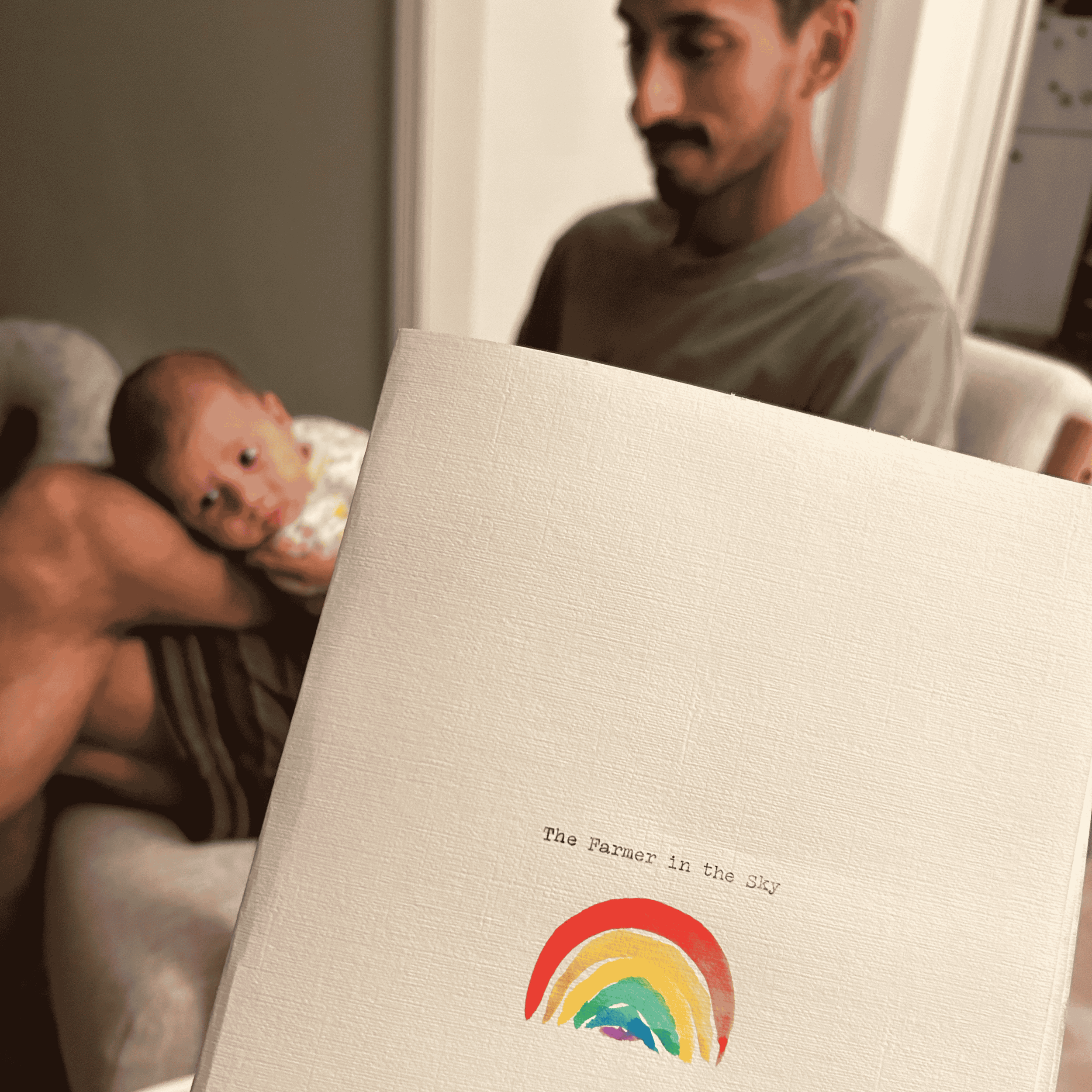 Close-up of a person holding a book with a rainbow illustration on the page. The person's face is partially visible, and the background includes a doorway and a white wall.