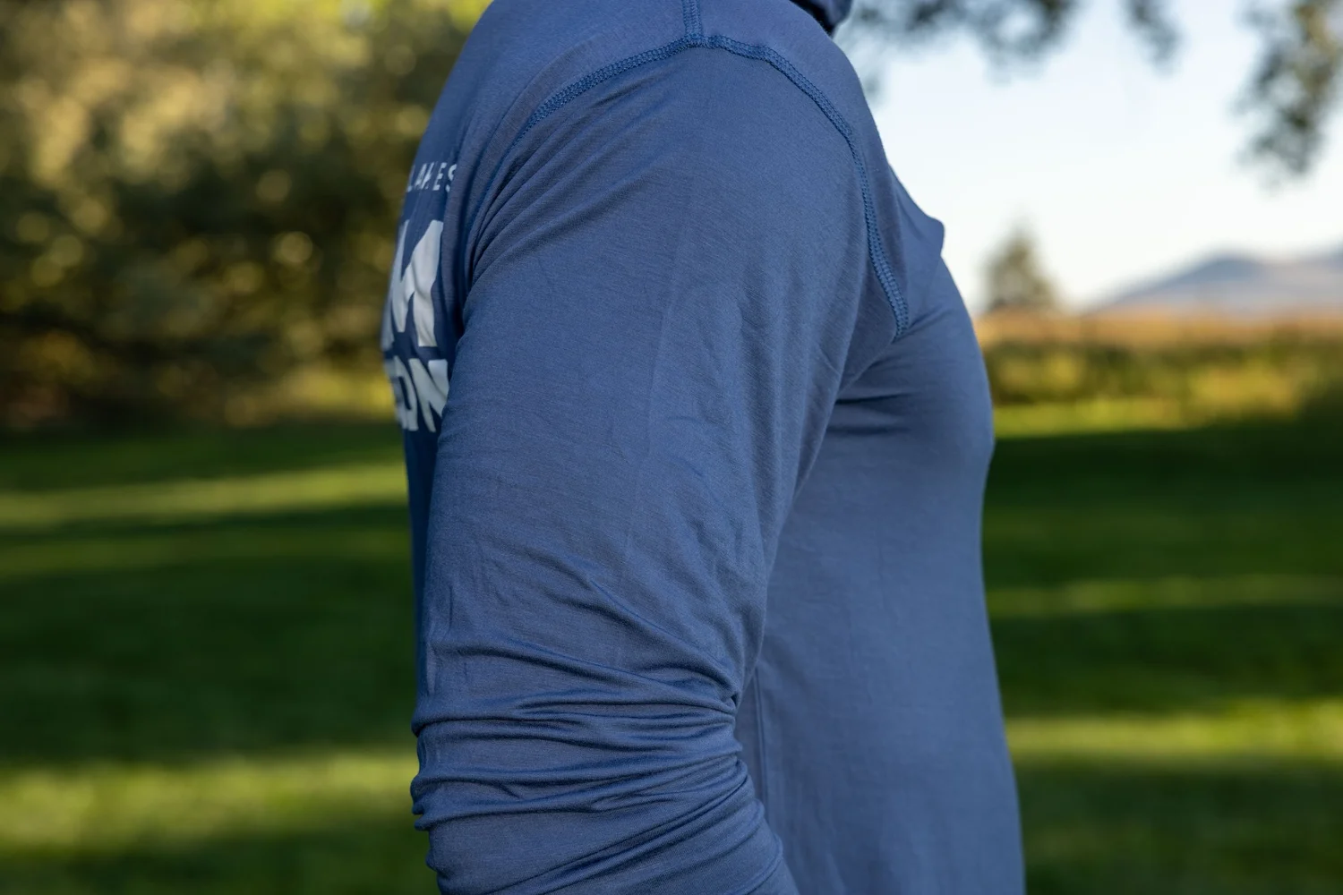 Close view of the sleeve fabric on the Fathom hooded sun shirt