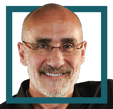 Close-up of a smiling middle-aged man with glasses, a beard, and a bald head, wearing a black shirt.