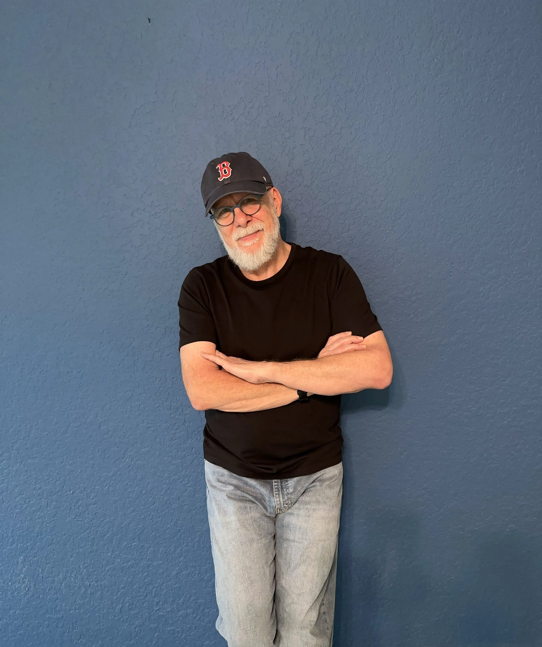 image of glenn standing against blue wall