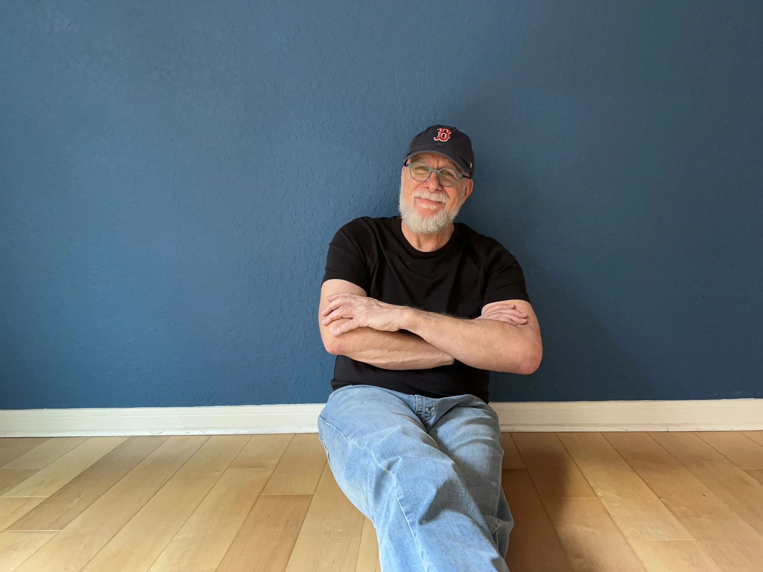image of glenn leaning on blue wall