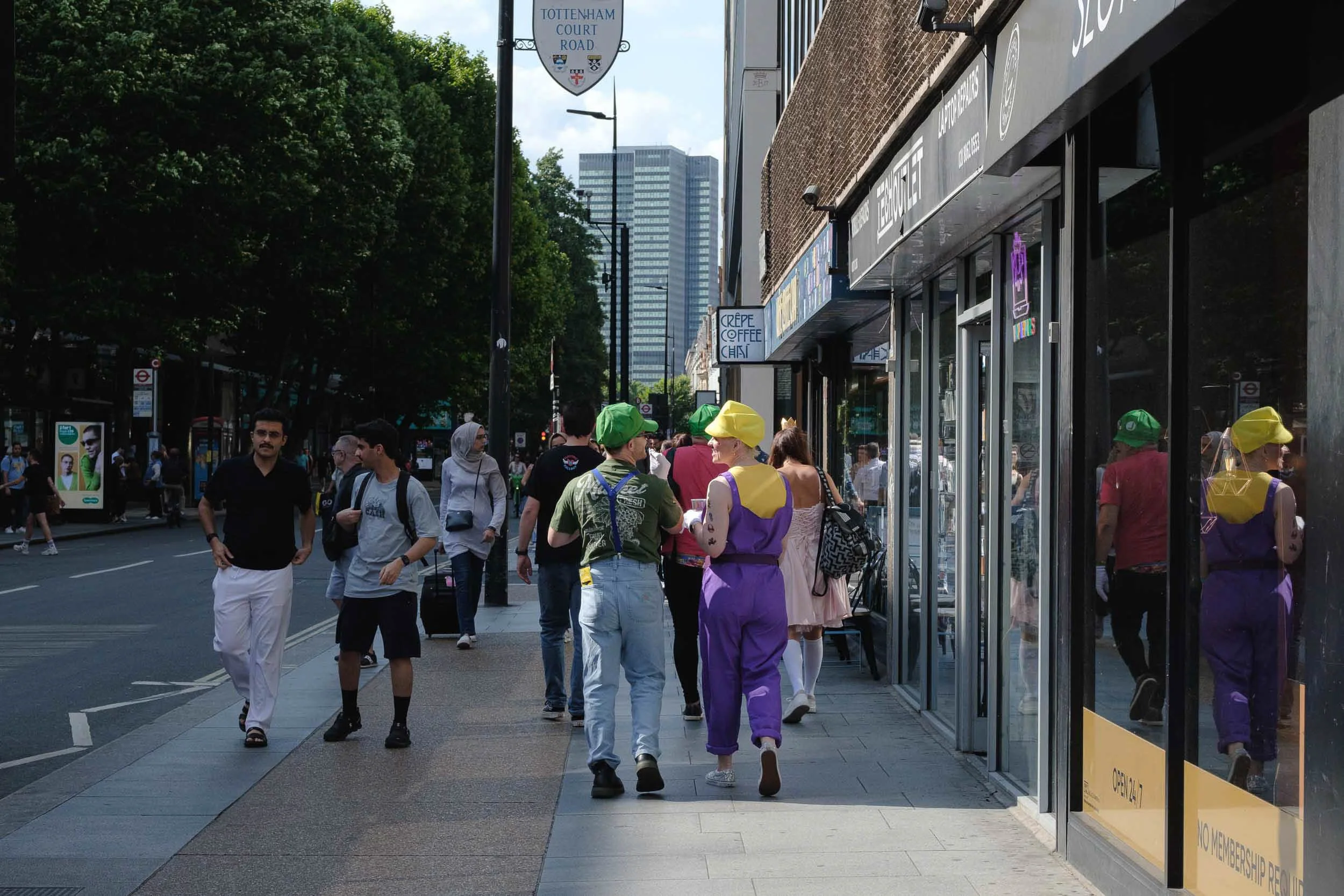 Revellers walk down Tottenham Court Road in London dressed as the Mario Bros in this surreal scene