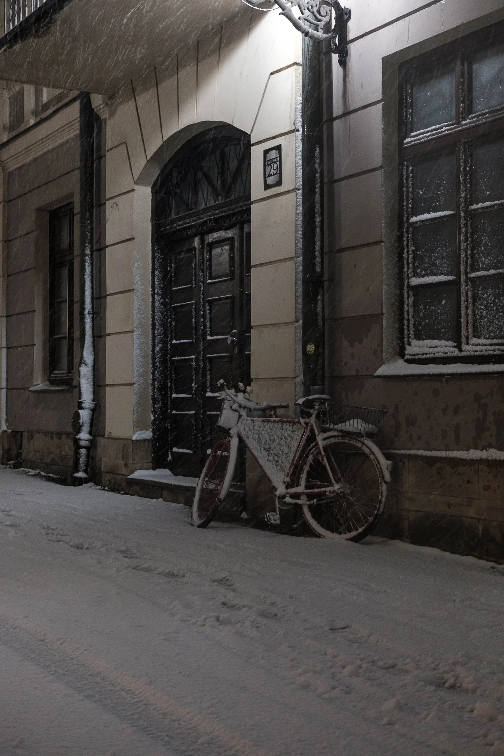 Winter scene of a snow covered bike locked up outside on the snow covered streets of Poland