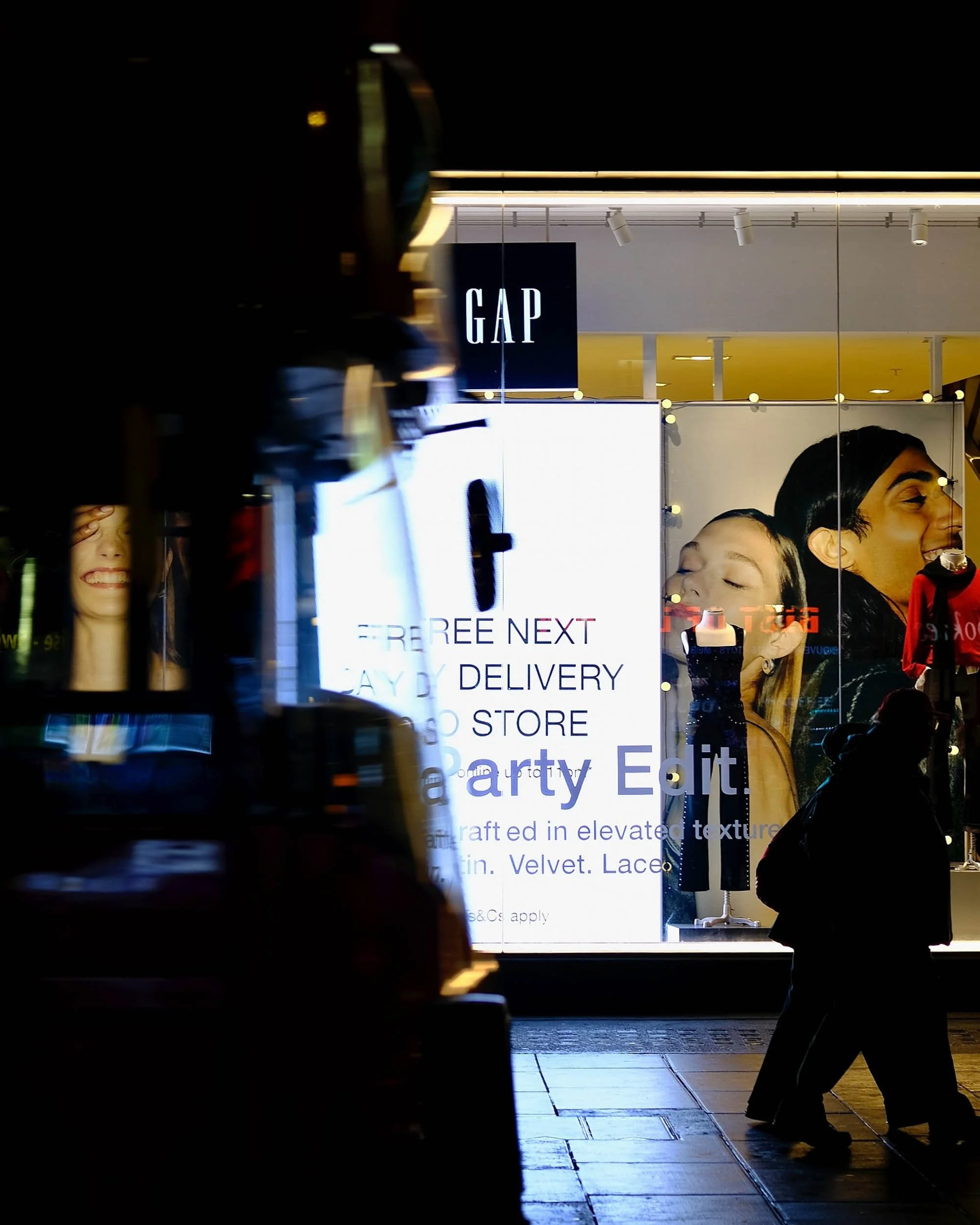 Motion blur of buss passing in front of retail displays on Oxford Street London creates an abstract scene