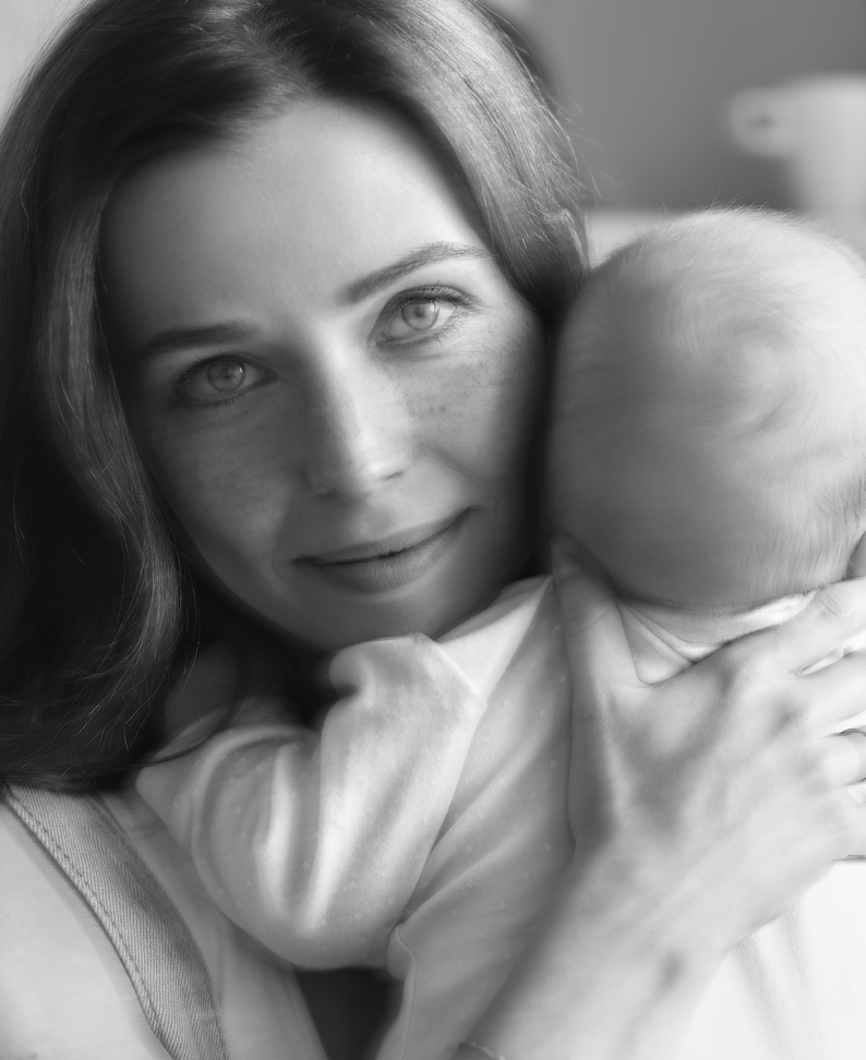 Woman holding a baby.