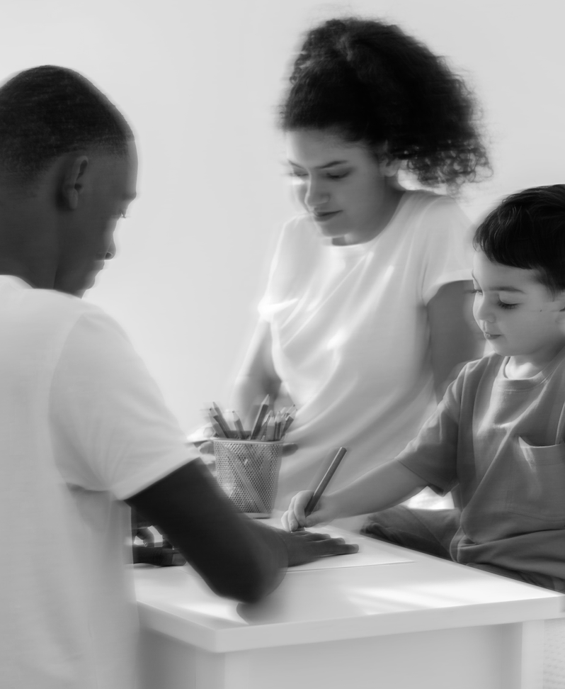 Family sitting together doing homework.