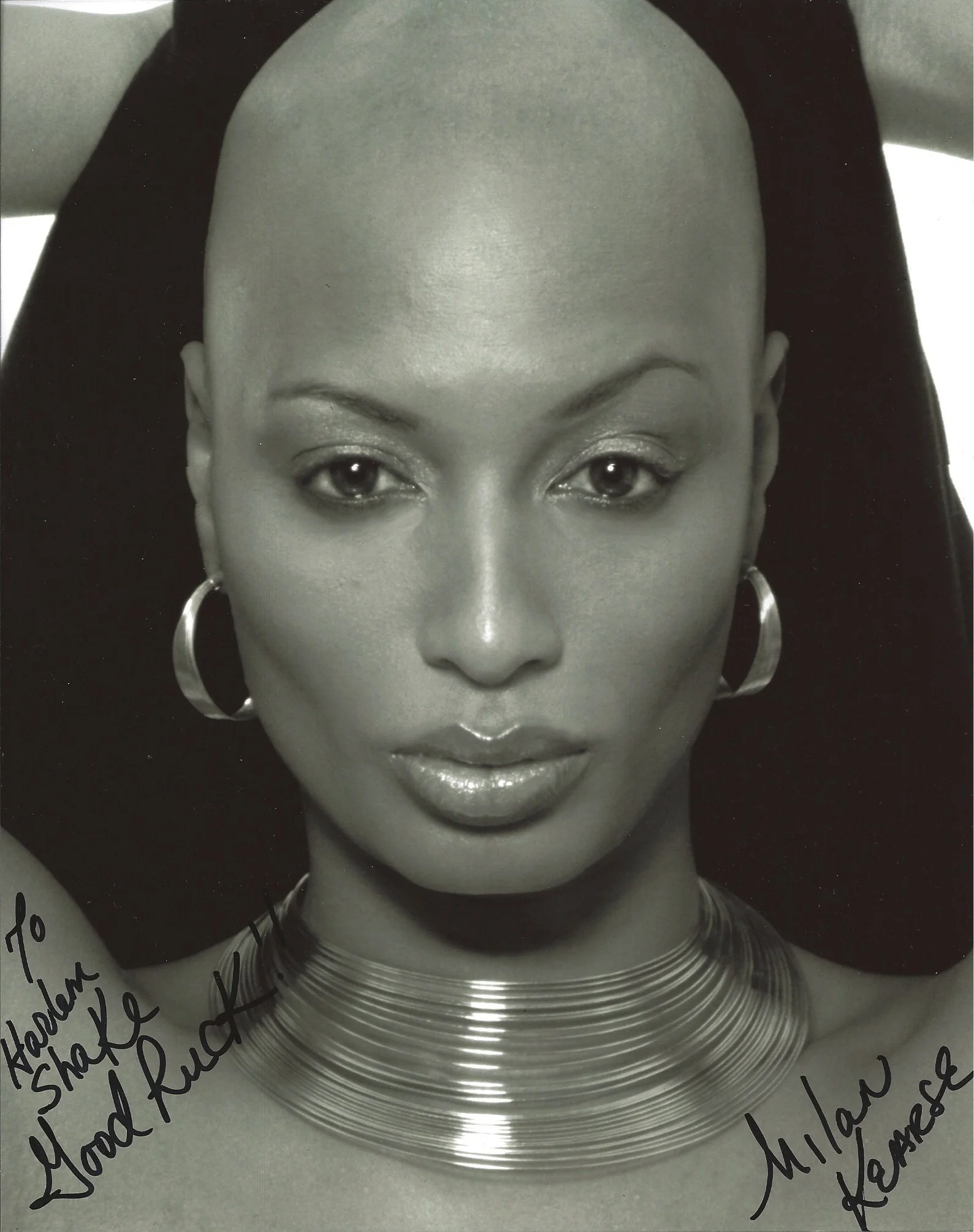 Close-up black-and-white photograph of a woman wearing earrings and a necklace, with handwritten notes around the image.