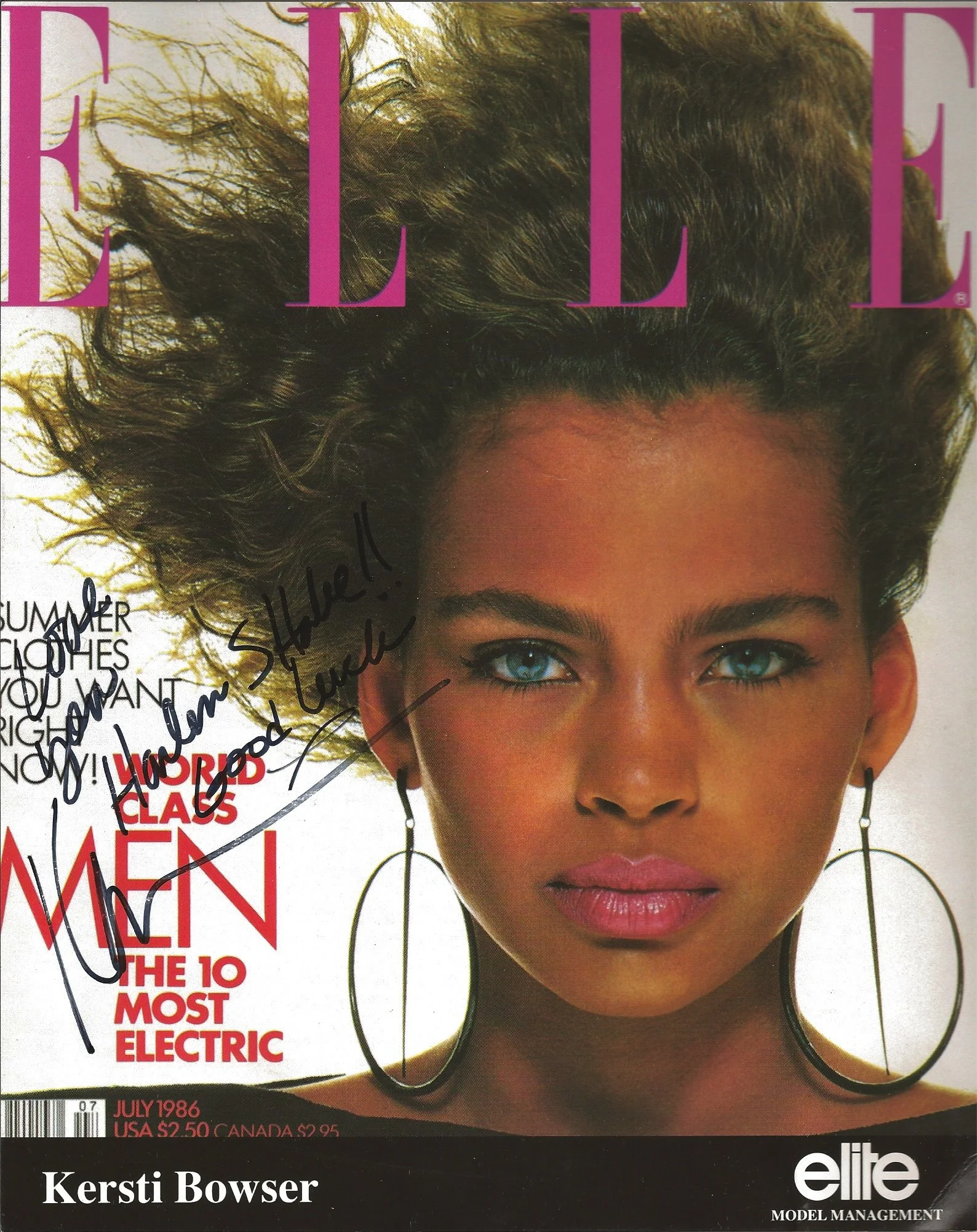 Cover of Elle magazine featuring a close-up of a woman with curly hair and blue eyes, signed with handwritten notes. The magazine is from July 1986, priced at $2.50 in the US and $2.95 in Canada, and includes articles on fashion, beauty, and style.