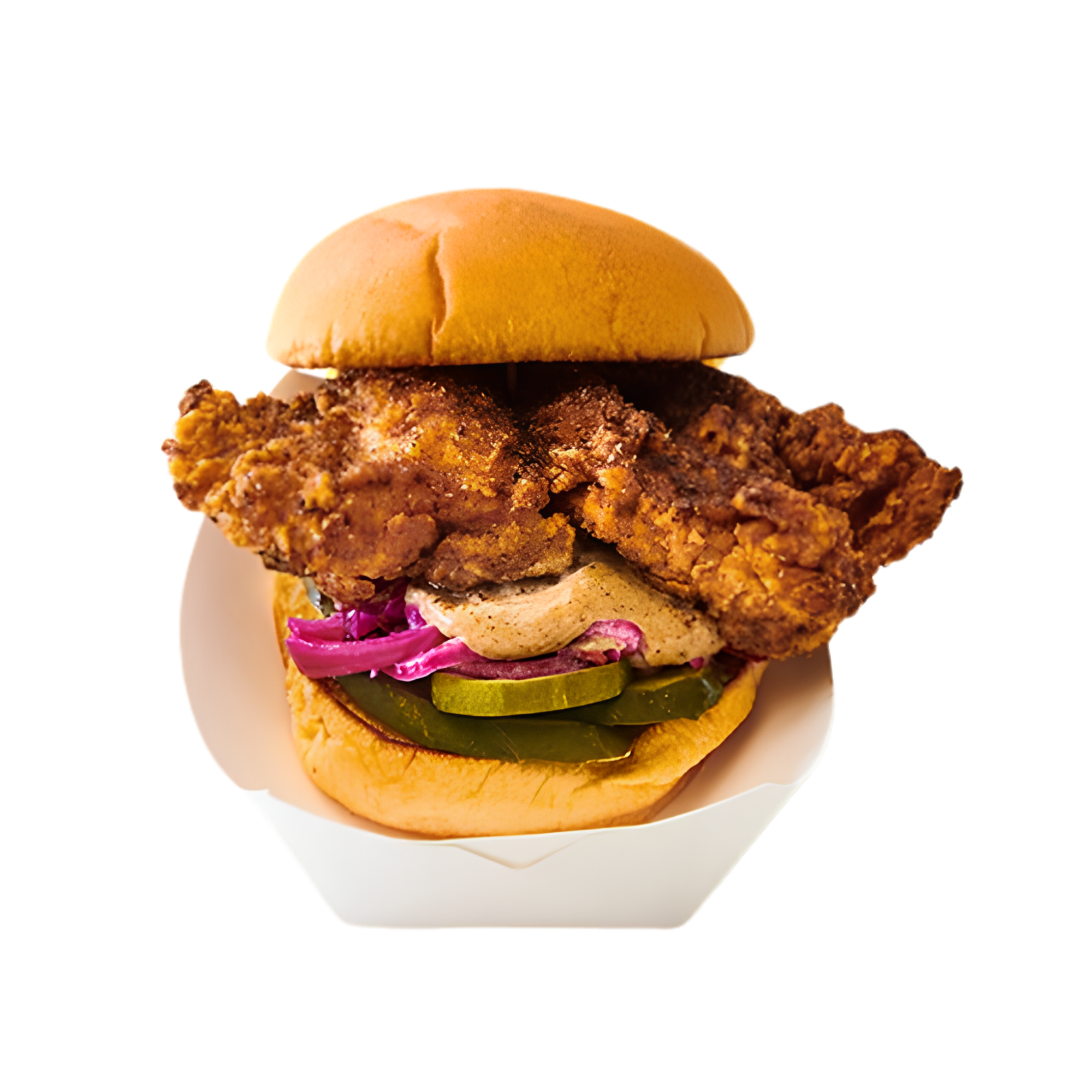 A fried chicken sandwich with pickles and purple cabbage slaw on a white bun, served on a white plate.