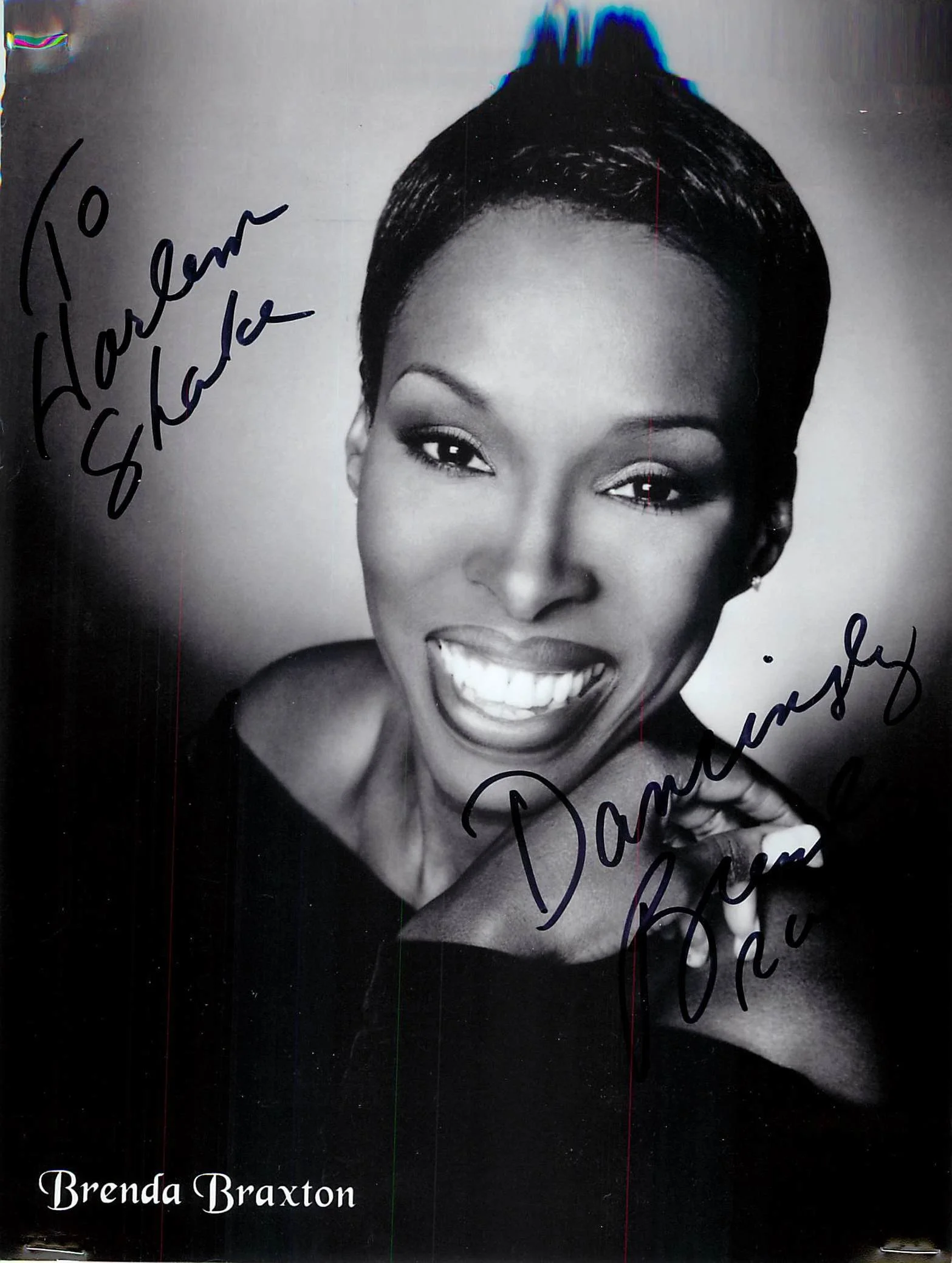 Black and white portrait of Brenda Braxton smiling, with handwritten signatures and messages on the photo.