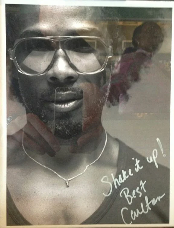 Black and white poster of a man wearing sunglasses and a necklace, with the slogans "Share it up!" and "Best Cuttar!" written on it.