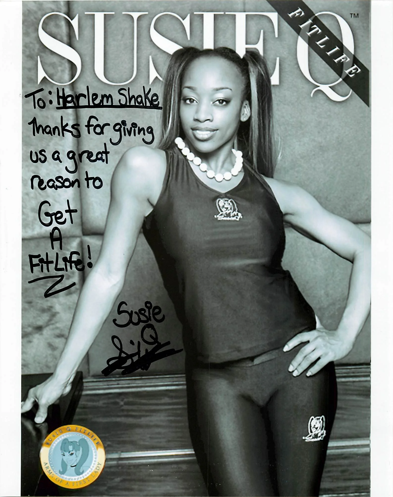 A black and white photograph of a woman with long hair tied in pigtails, wearing a tank top and leggings, standing with one hand on her hip. The image has handwritten text in black ink covering part of the photo, including a message: "To: Harlem Shak