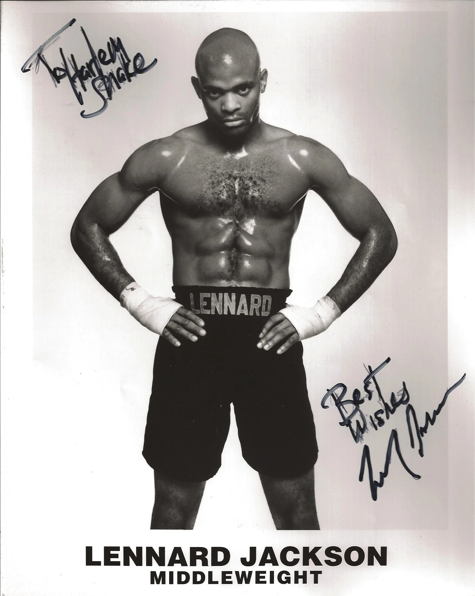Black and white photograph of a shirtless male boxer with hands on hips, wearing boxing shorts with the name "Lennard" on the waistband. The image includes handwritten signatures, and the text "Lennard Jackson Middleweight" is printed at the bottom.