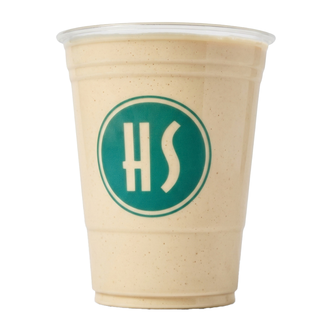 A large plastic cup filled with a creamy, light-colored beverage with small specks, featuring a teal logo with the letters 'HS' on the front.