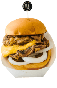 A cheeseburger with a beef patty, melted cheese, onions, lettuce, and a bun, garnished with a toothpick that has a logo on it.