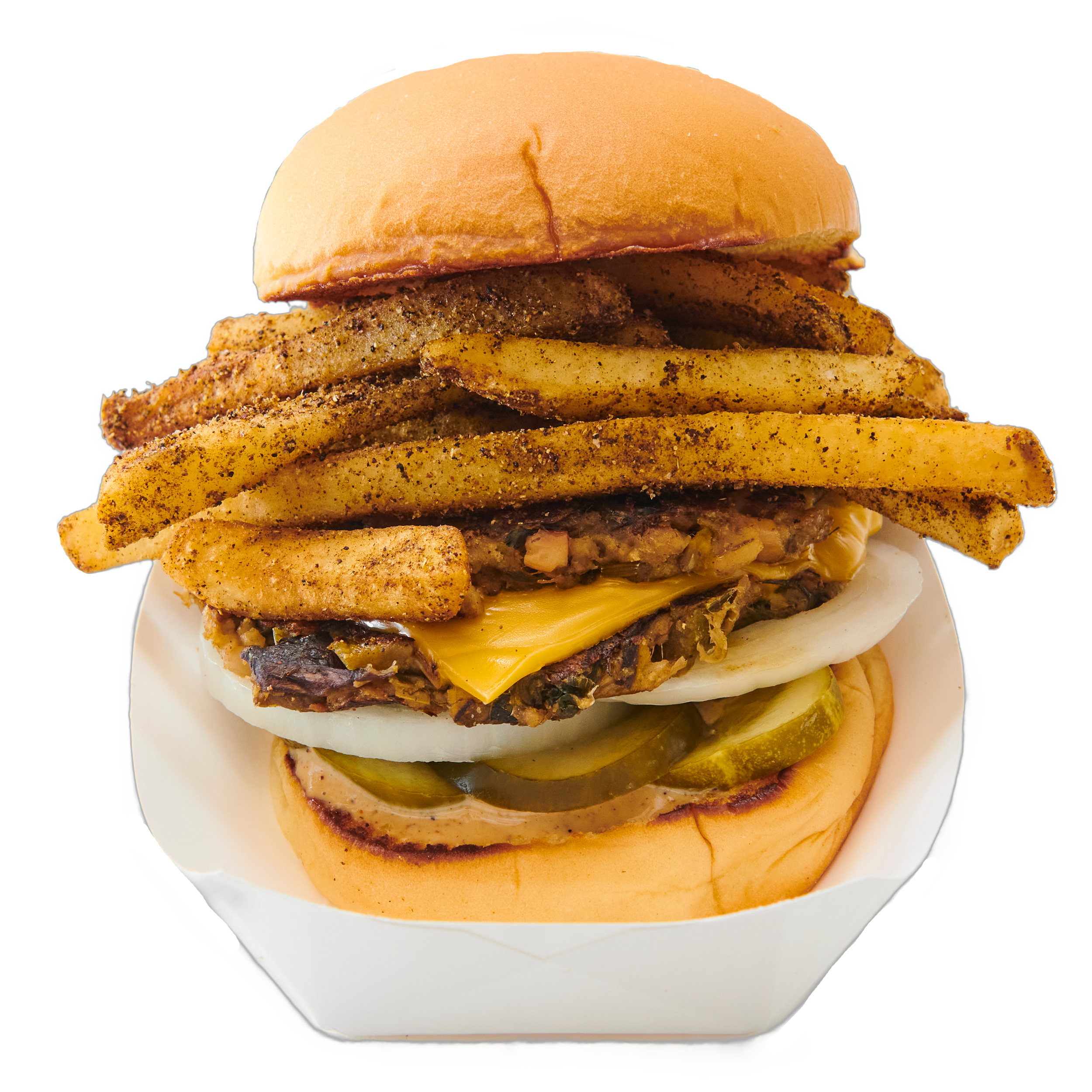 Close-up of a burger with fried chicken fillet, cheddar cheese, pickles, and crispy fried potato slices in a white paper container.