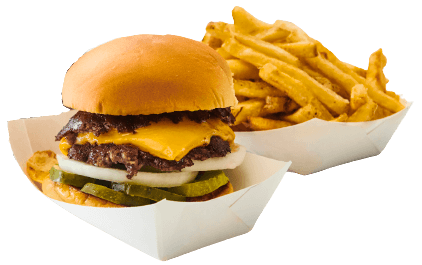 A cheeseburger with a beef patty, melted cheese, pickles, onions, and a bun, served alongside seasoned French fries.