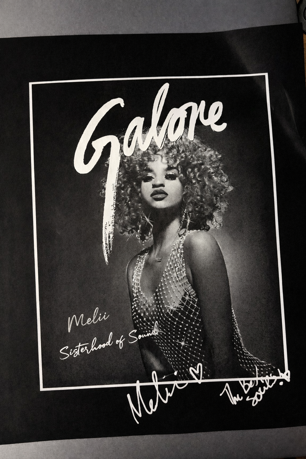 Book cover featuring a black-and-white photo of Melie with curly hair, wearing a jeweled top, with the title "Galone" in large script at the top and her name with a message at the bottom.