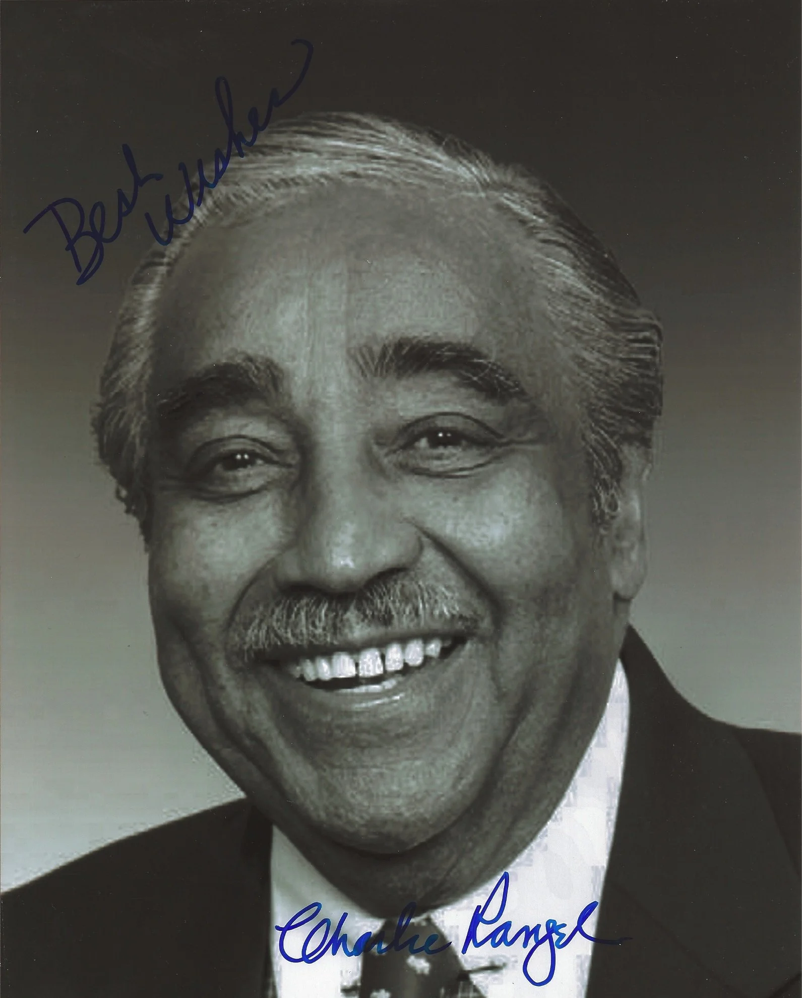 Black and white portrait of a smiling man with white hair, dark eyebrows, and a mustache. Text handwritten in blue ink says 'Behind the window' and 'Charlie Rangel'.