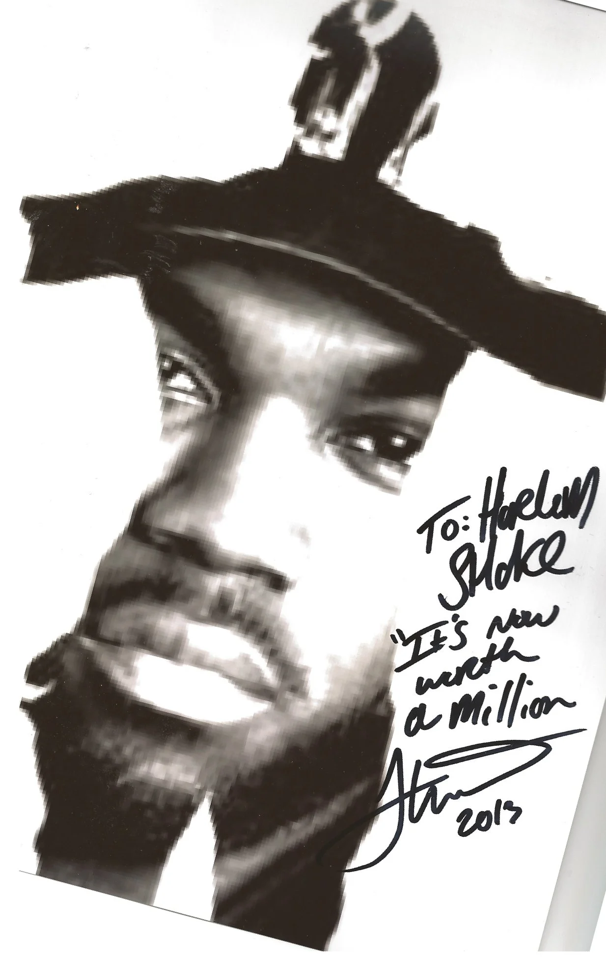 A black and white photo of a man in a suit, with a handwritten message and signature on the right side that reads, 'To: Harlem Shake 'It's now worth a million' 2013'.