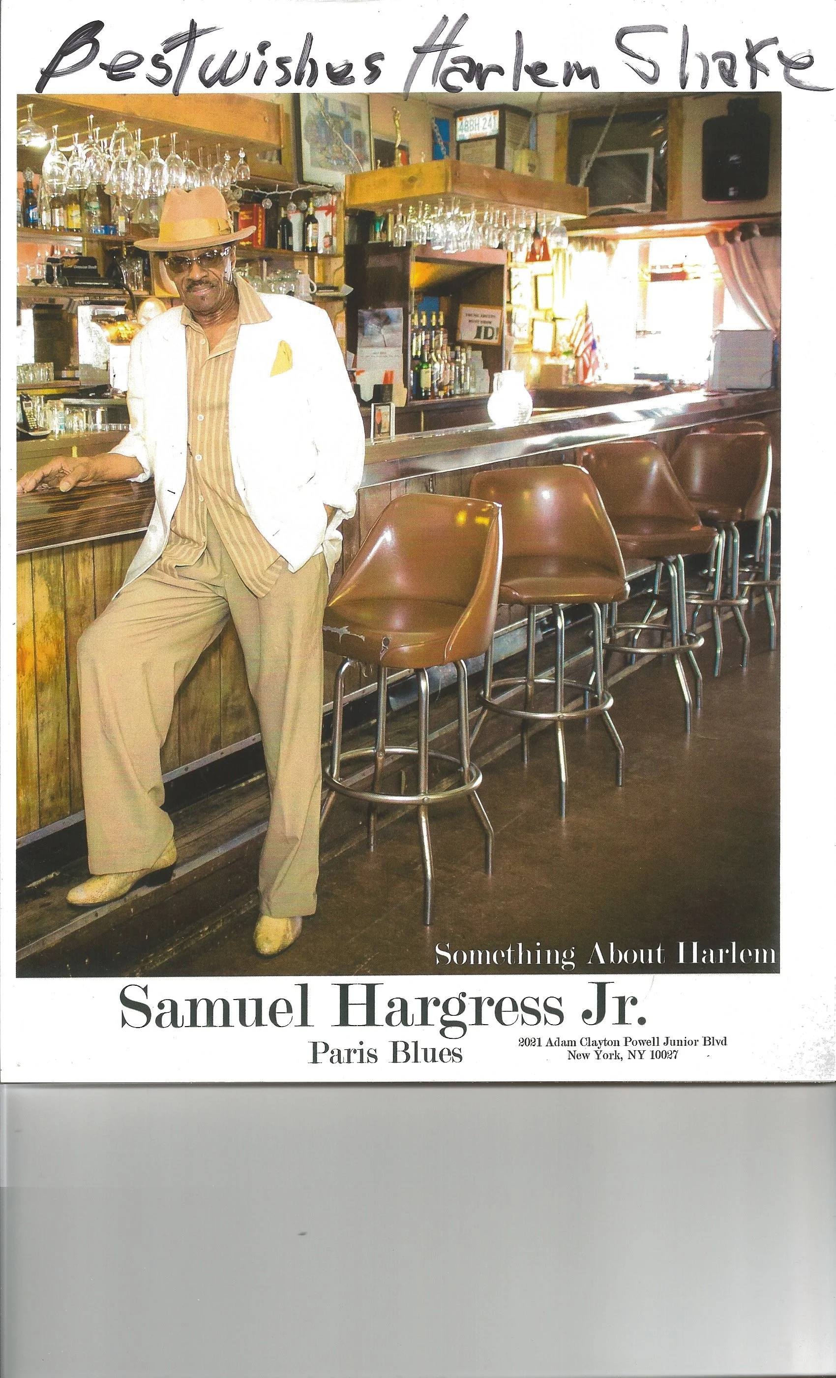 Cover of a book titled "Something About Harlem" featuring Samuel Hargress Jr. in a vintage bar setting, wearing a light-colored suit, hat, and glasses, with a background of bar shelves and wine glasses.