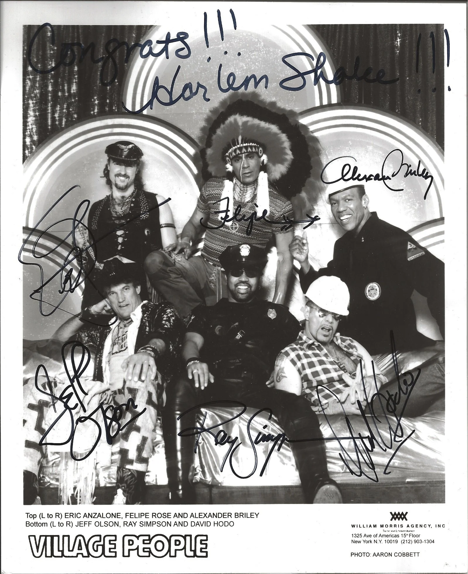 Black and white group photo of six people, labeled top to bottom as Eric Anzalone, Felipe Rose, Alexander Briley, Jeff Olson, Ray Simpson, and David Hodo, with signatures and congratulatory message at the top reading 'Congrats!!' and 'You l'em Shalee
