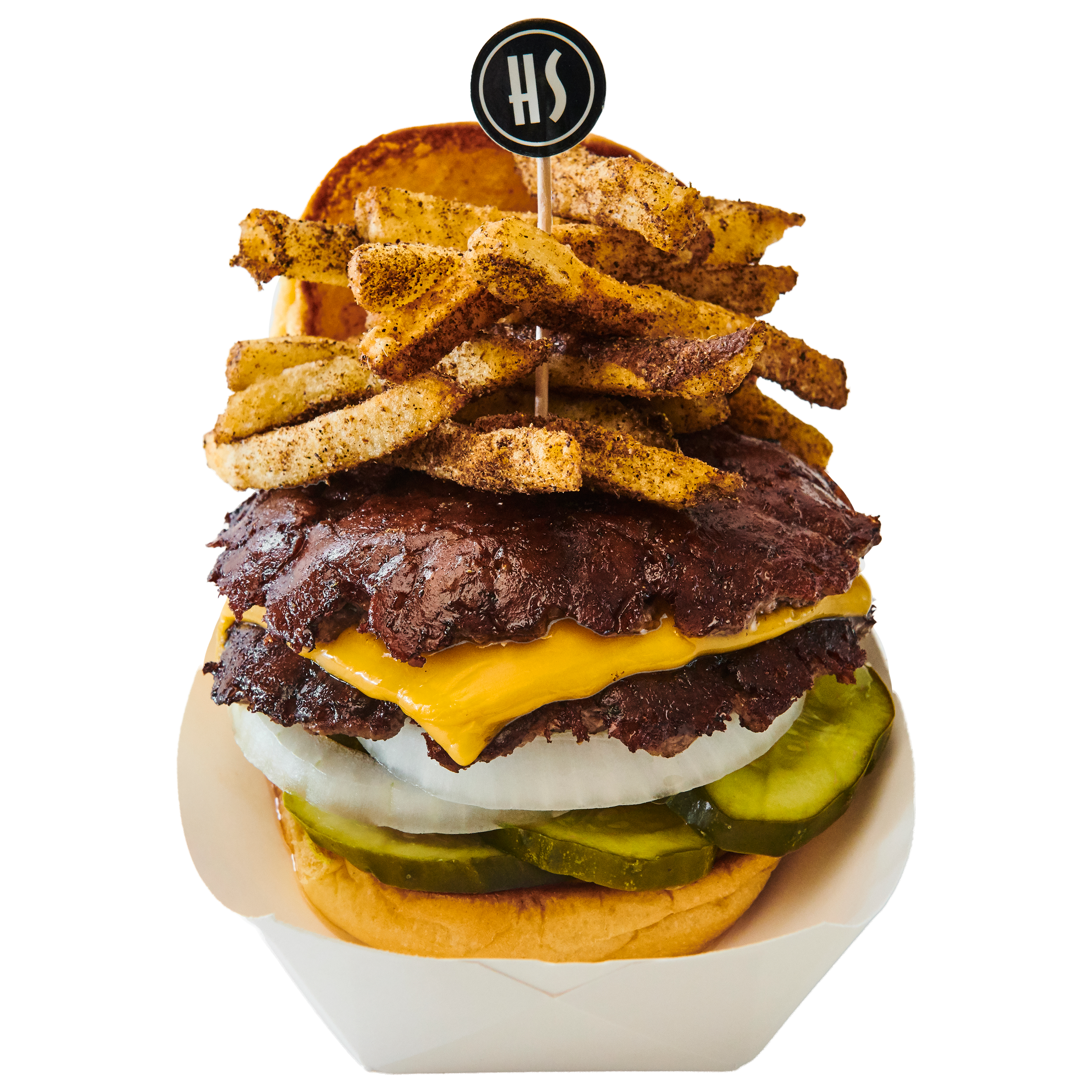 A burger with multiple beef patties, cheddar cheese, pickles, onions, and bun, topped with seasoned potato chips and a small sign with the letters 'SH'.