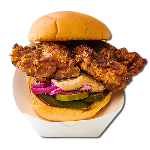 Fried chicken sandwich with pickles, purple onion, and sauce in a bun
