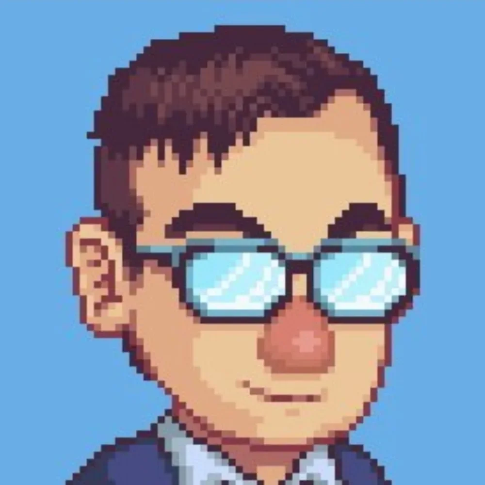 Pixel art image of Spire of Arkodea's developer. It's a closeup of his head - he has short brown hair, and is wearing glasses with reflective lenses, set against a blue background.