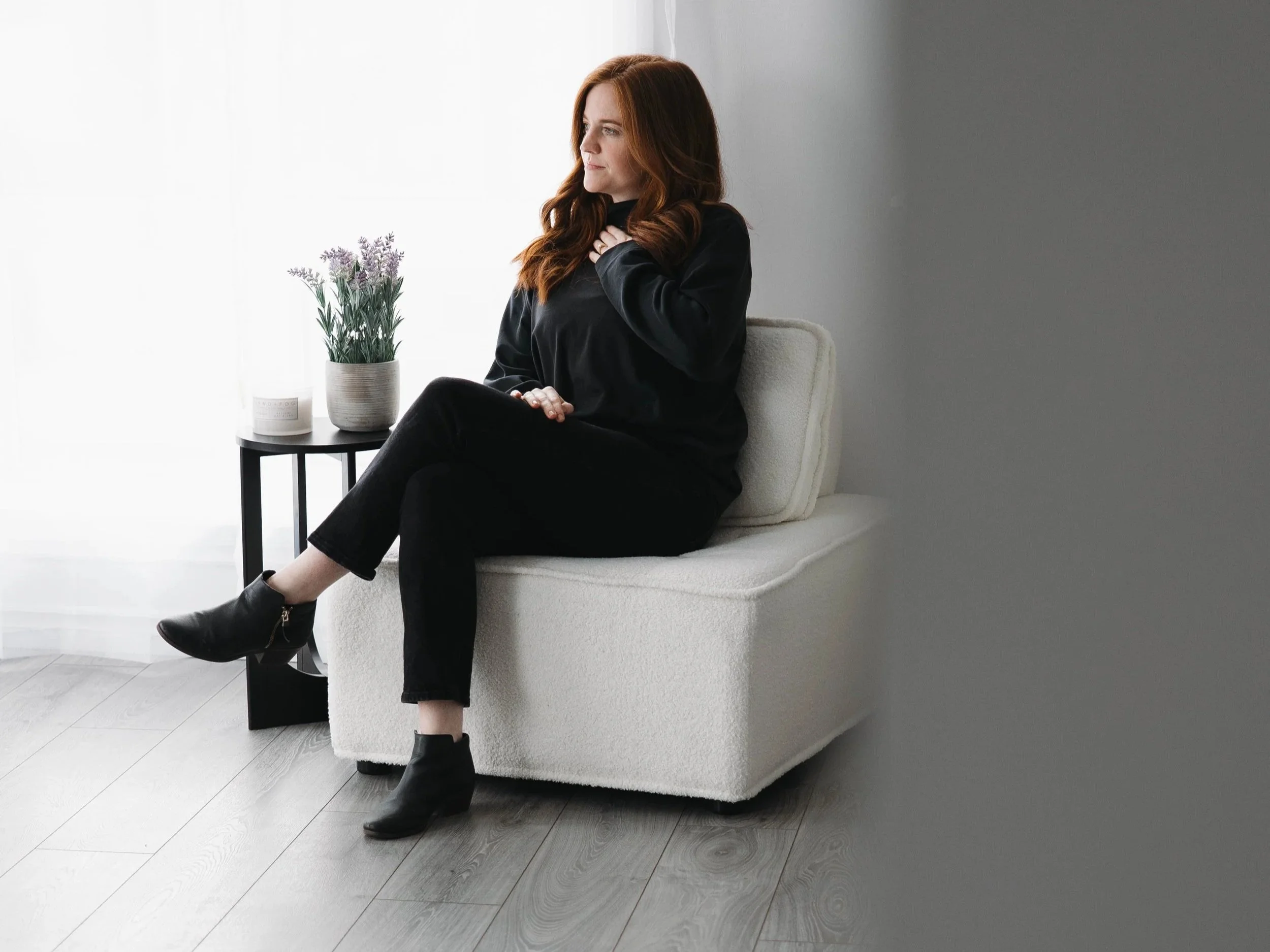 A woman waiting in a chair for someone.
