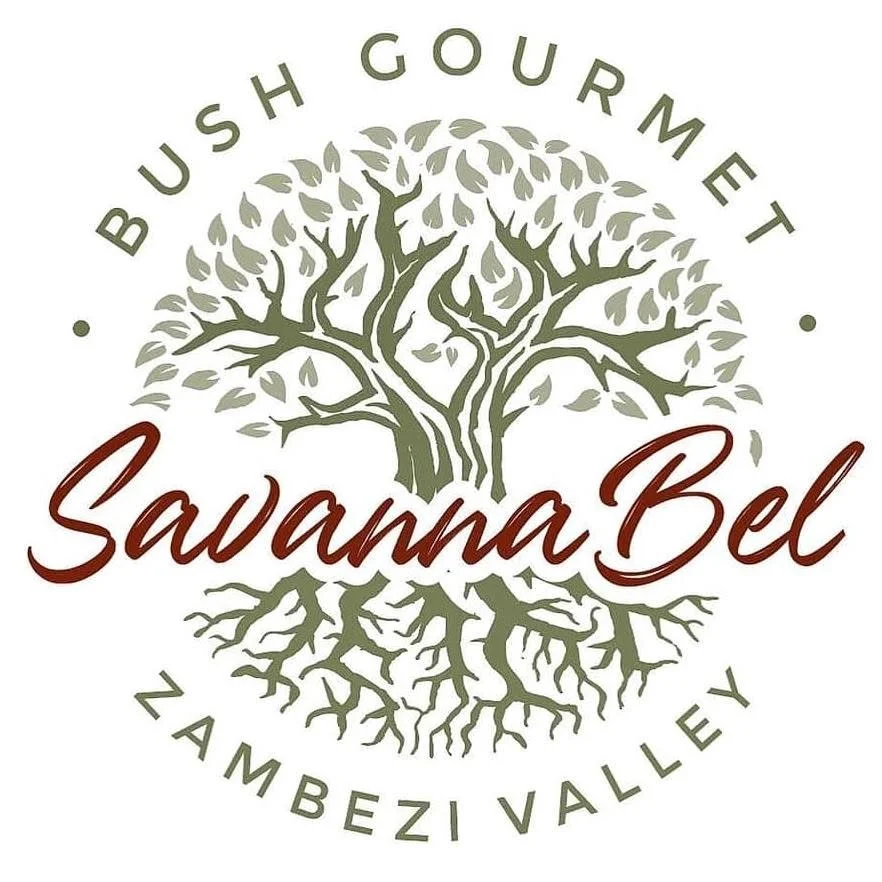 Logo featuring the name 'Sawanna Bel' with a stylized tree with roots and branches, and the text 'Bush Gourmet' above it and 'Zambezi Valley' below.