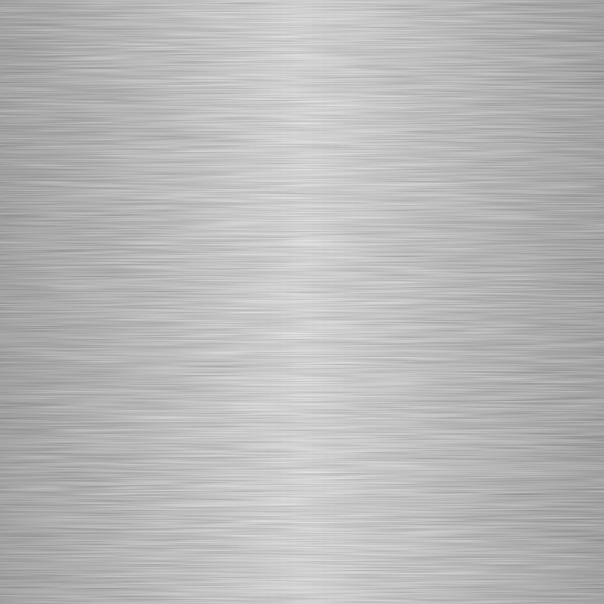 A close-up of a metallic, brushed silver surface with parallel lines.