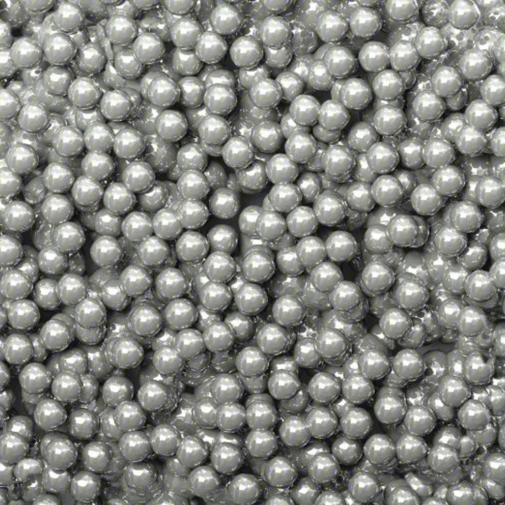 Close-up view of numerous shiny metallic spherical balls tightly packed together.