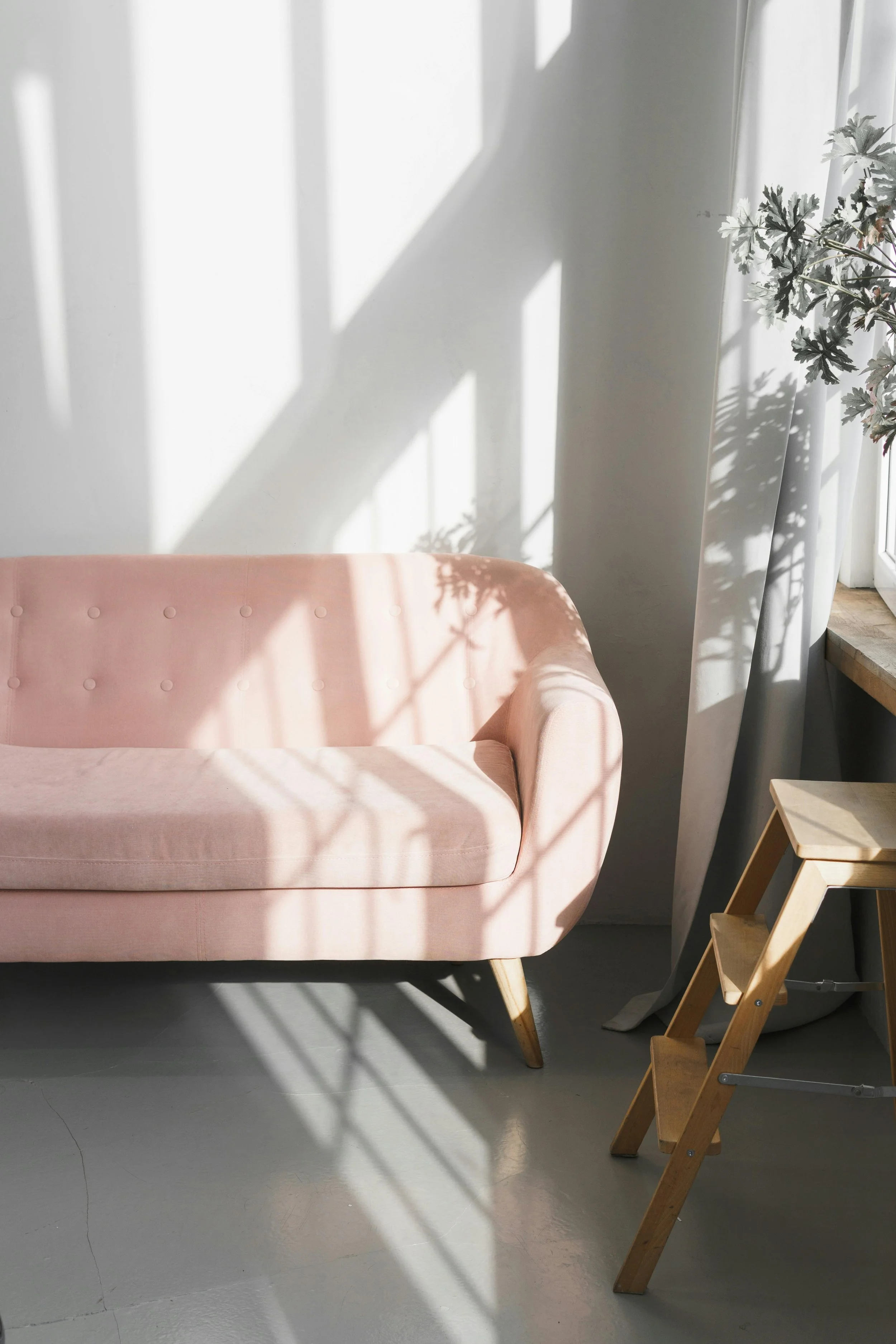 Warm, sunlit therapy office with a pink sofa and natural light — a welcoming space for individual and couples counseling in Ogden, Utah