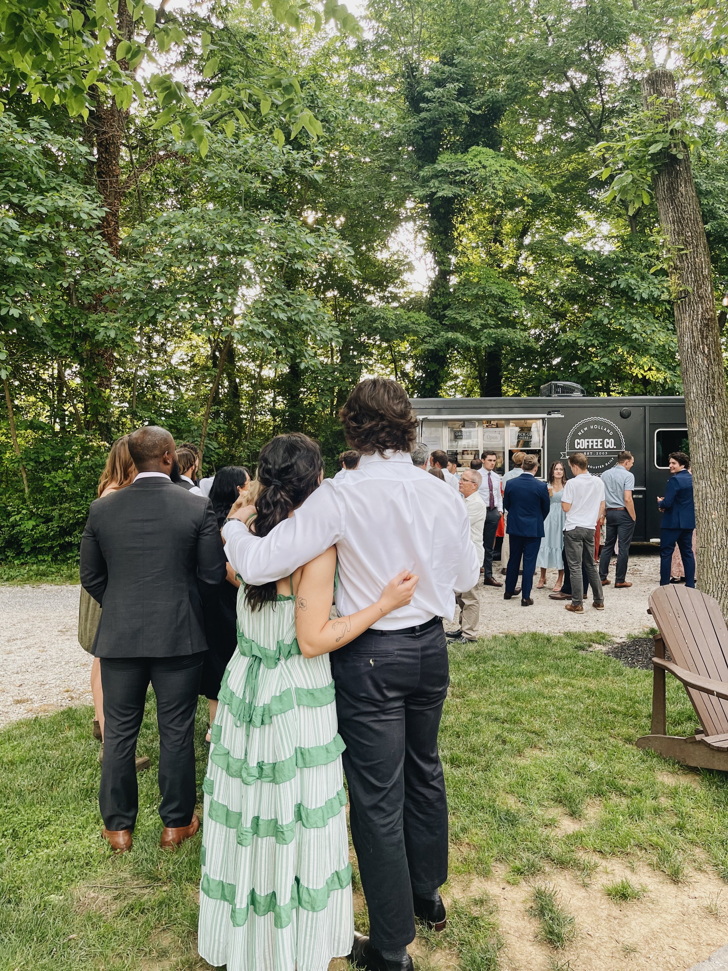 Wedding guests socializing near the New Holland Coffee Truck