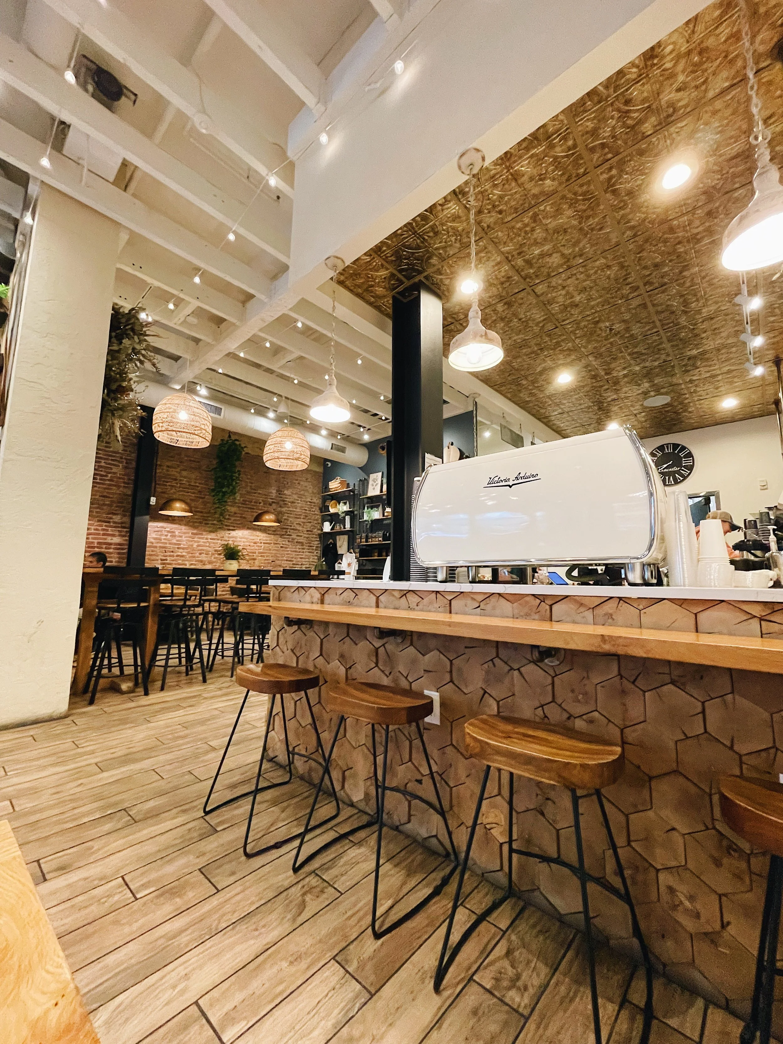 Interior view of New Holland Coffee Lancaster City location with espresso machine.