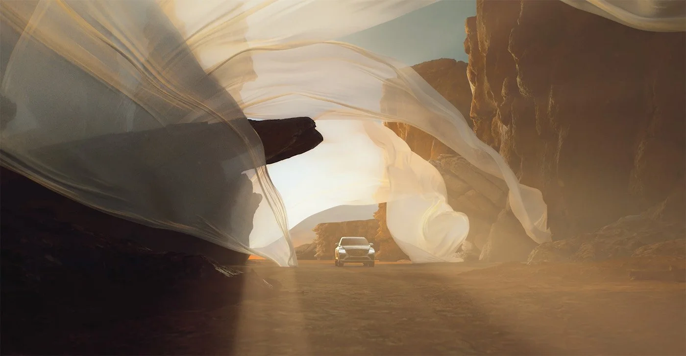 A car driving through a narrow canyon with high rock walls and flowing white sandstone formations.
