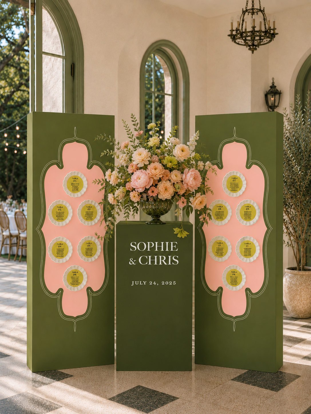 Seating chart display with floral arrangements, green and pink decorative panels, and a sign with the names Sophie and Chris, dated July 24, 2025, at a wedding event.