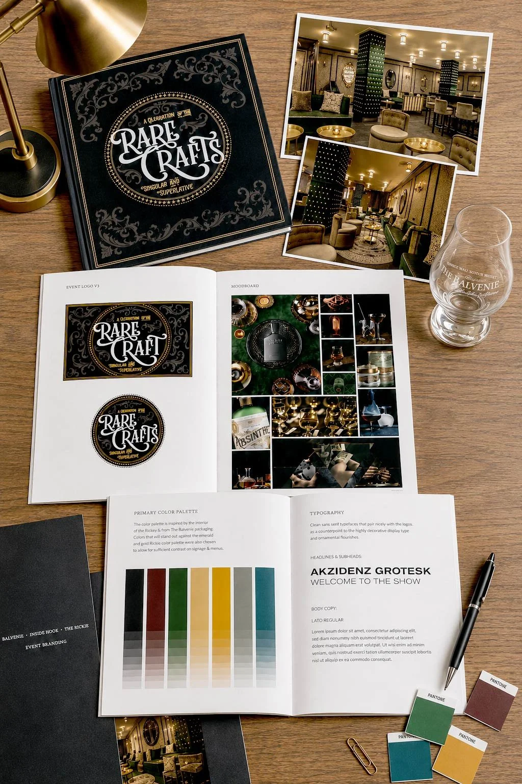 Design mood board and branding materials for a project called 'Rare Crafts,' featuring a black and gold logo, interior photos of a sophisticated bar or lounge, color palette, and branding documents on a wooden desk with a pen.