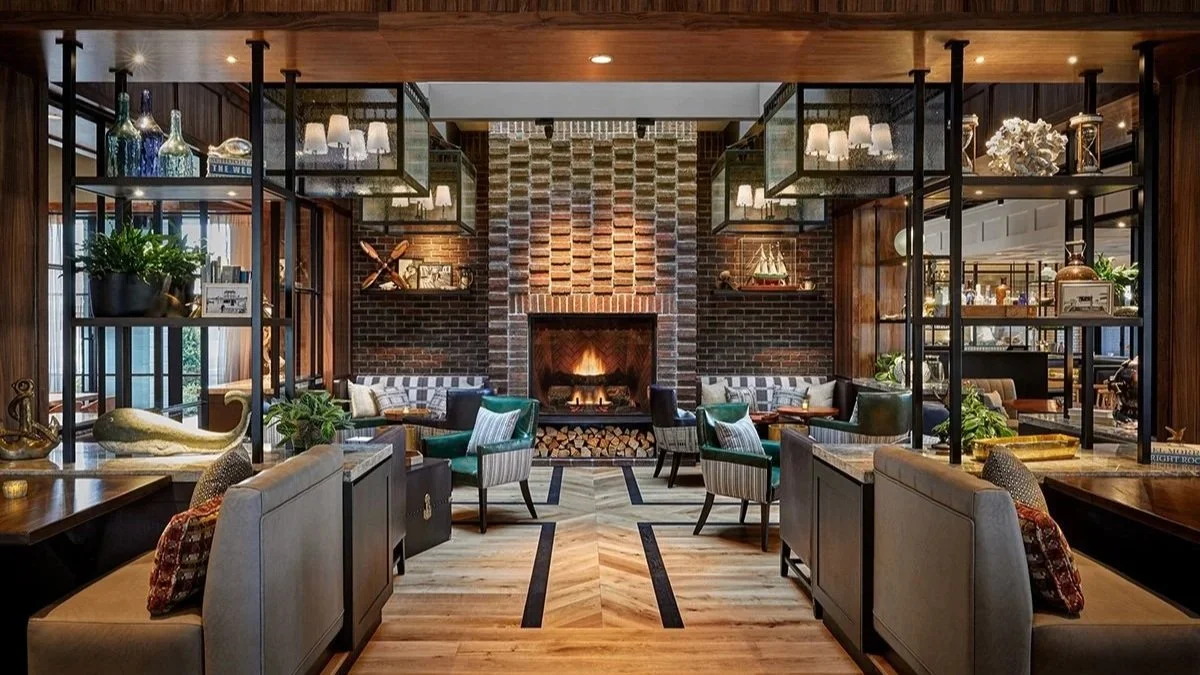 Lido House interior with fireplace and seating.