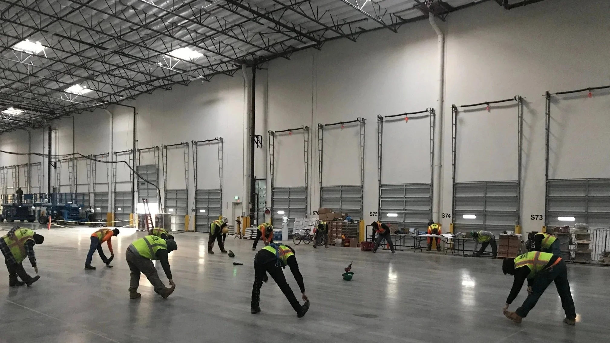 Mammoth Electric team stretching in warehouse