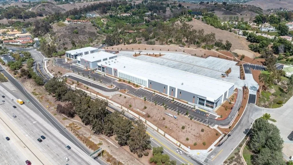 aerial shot of a commercial and industrial development by the freeway