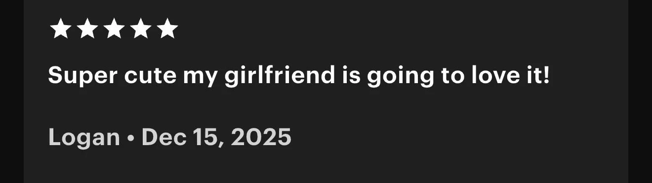 Five white stars on a black background, with white text below that reads "Super cute my girlfriend is going to love it!" and smaller gray text displaying "Logan · Dec 15, 2025".