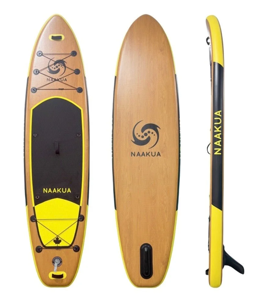 A yellow and black stand-up paddleboard with the brand name NAAKUA, shown from top, bottom, and side views, with a wooden deck, black traction pad, and a fin at the bottom.