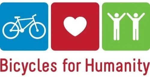 Icons representing a bicycle, a heart, and two people with their arms raised, with the words 'Bicycles for Humanity' underneath.