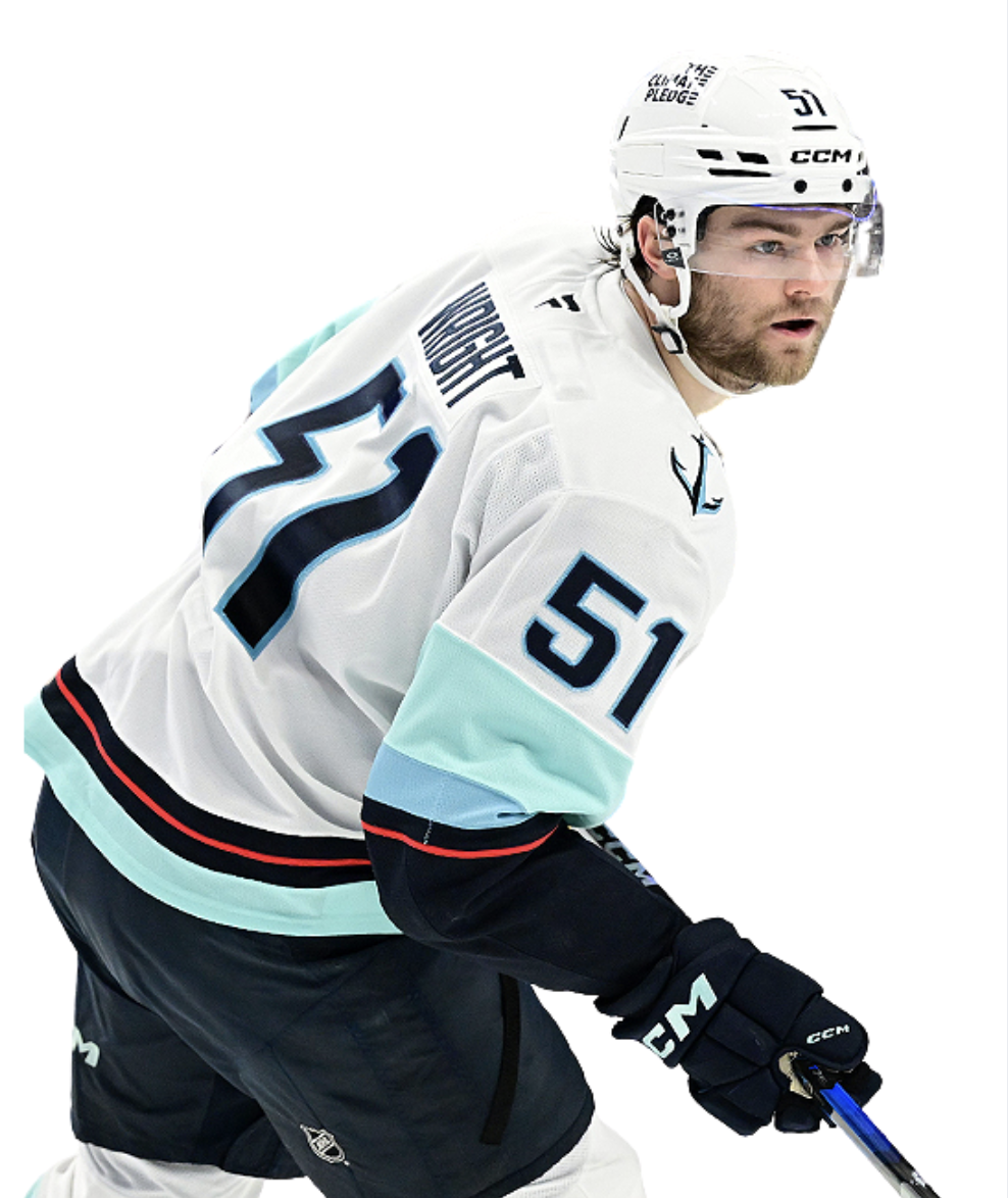 An ice hockey player in a white jersey with the number 51, wearing a helmet and gloves, holding a hockey stick, and looking forward during a game.