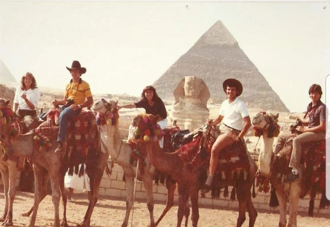Tourists riding camels near the Great Pyramid of Giza in Egypt