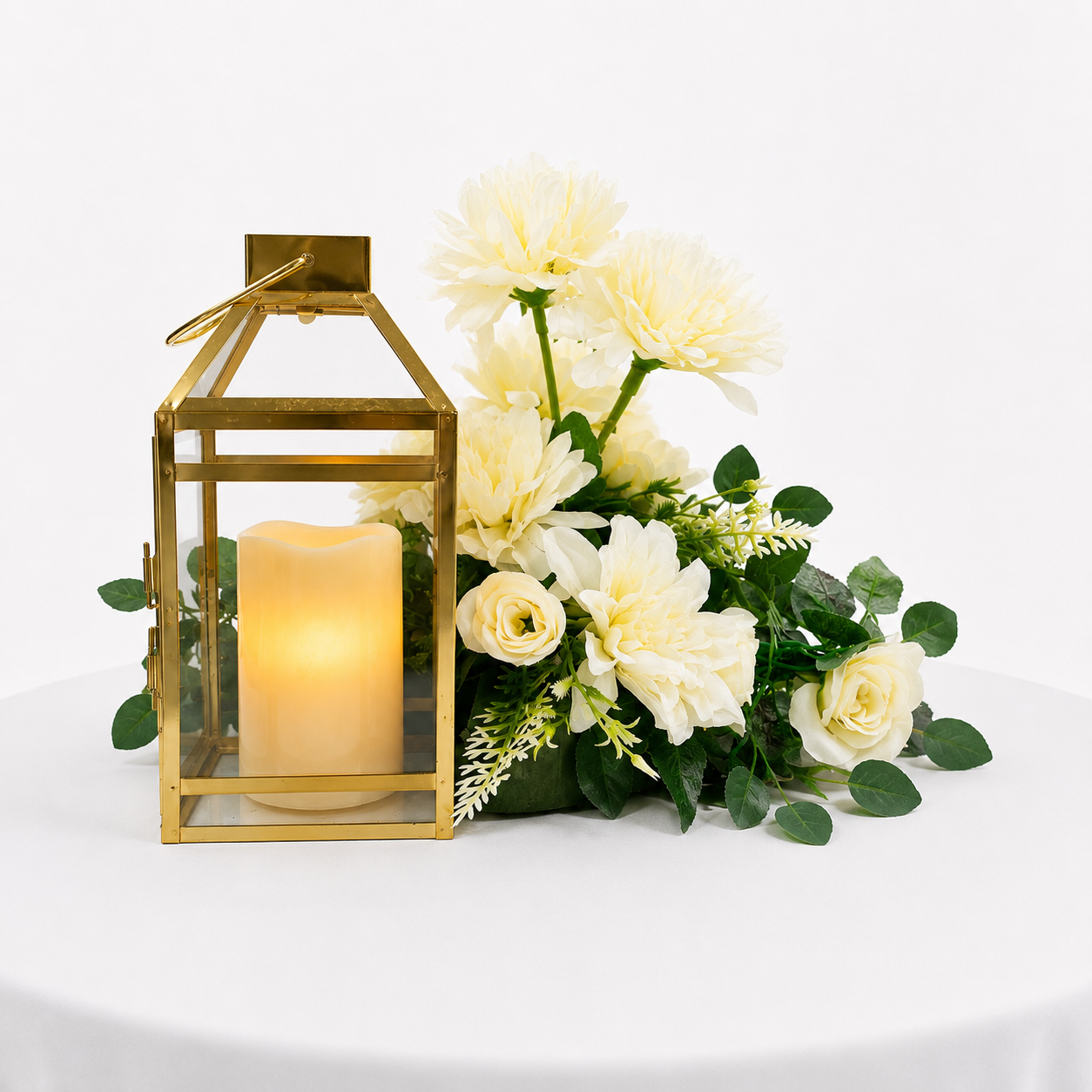 Candle lit gold lantern with white flower arrangment