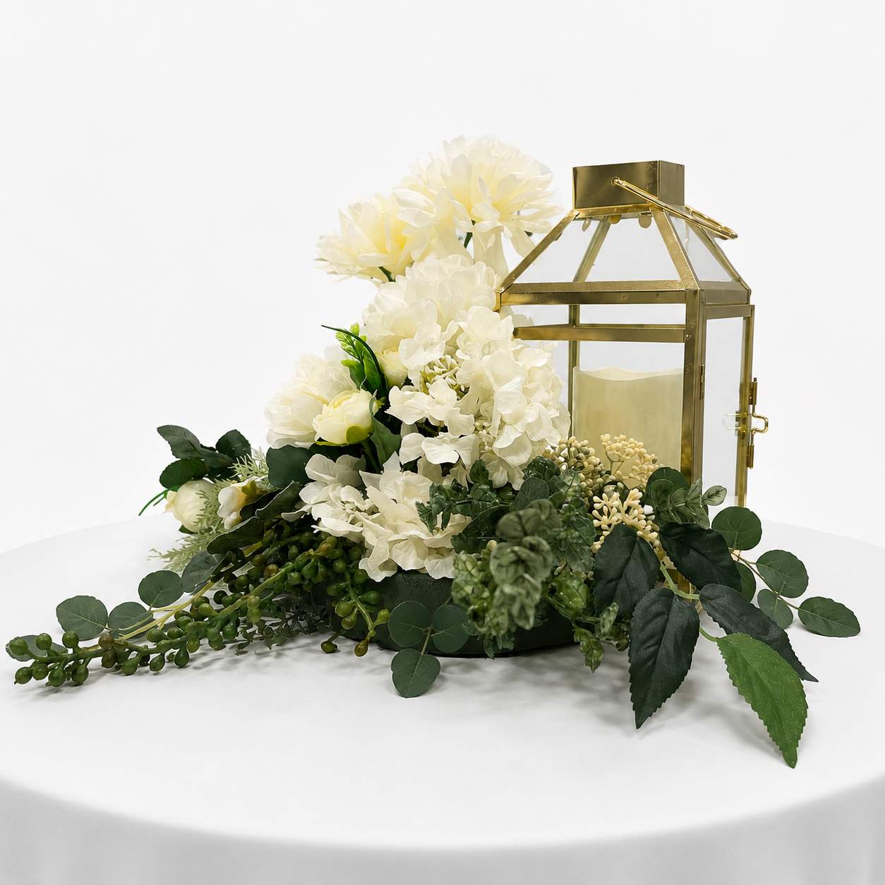 Corner view of gold lantern and custom flower arrangement centrepiece.